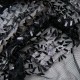 Au mètre, tissu avec mini languettes accrochées au fil polyester noir, effet pailleté et brillant en 145cm n°11003